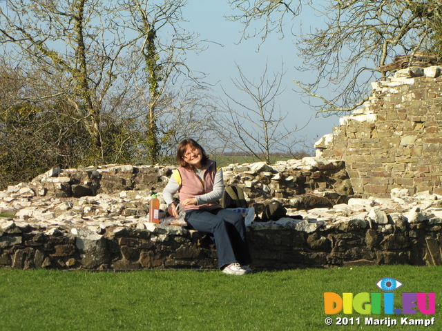 SX17253 Jenni sitting in the sun preparing lunch at Llawhaden Castle